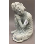 A porcelain model of sleeping Buddha