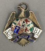 A silver enamel eagle pendant