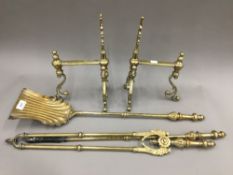 A set of Victorian brass fire irons and a pair of fire dogs