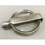 A silver folding magnifying glass