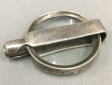 A silver folding magnifying glass