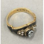 An 18 ct gold and enamel mourning ring (3.