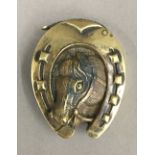 A brass horseshoe vesta