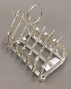 A silver plated rifle toast rack