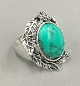 A silver and turquoise ring