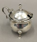 A silver mustard pot