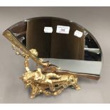A gilt bronze cherub fan mirror