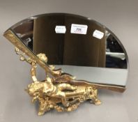 A gilt bronze cherub fan mirror