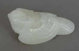 A Chinese carved white jade bird, naturalistically carved. 6 cm wide.