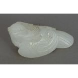 A Chinese carved white jade bird, naturalistically carved. 6 cm wide.