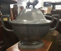 A large pewter tureen and cover with lion finial