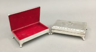A matched pair of Dutch silver lidded trinket boxes with swing handles and paw foot (429 grammes
