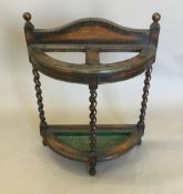An early 20th century oak barley twist stick stand
