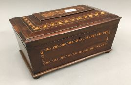 An inlaid yew wood triple compartment tea caddy