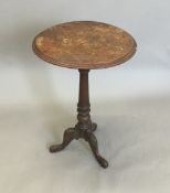 A Victorian inlaid tilt top tripod table