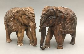 A pair of Eastern carved wooden elephants