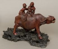 A 19th century Chinese well carved group of boys riding a water buffalo,