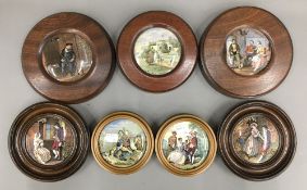 A collection of framed pot lids