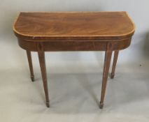 A 19th century mahogany fold over card table