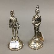 Two silver menu/place holders, modelled as soldiers in uniform,