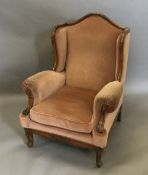 An upholstered wing armchair