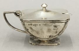 A silver mustard pot