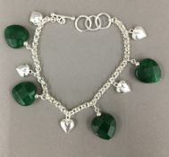 A silver and jade heart bracelet