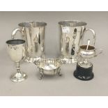 Two plated tankards, a small silver trophy cup, a small silver sauce boat, etc.