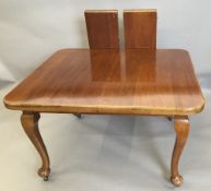 An early 20th century mahogany two leaf extending dining table