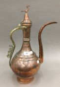 A Middle Eastern copper and brass ewer