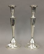 A pair of sterling silver candlesticks