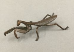 A bronze model of a praying mantis