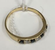 An 18 ct gold diamond and sapphire ring