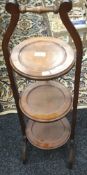 An early 20th century mahogany folding cake stand