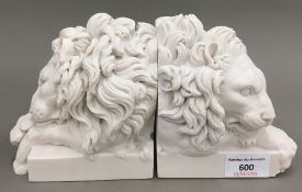 A pair of lion mask bookends