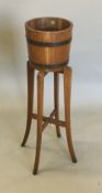 An early 20th century oak jardiniere stand