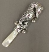 A silver seahorse rattle