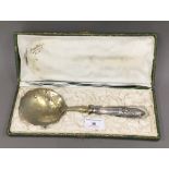 An unmarked Continental silver and silver gilt boxed strawberry spoon