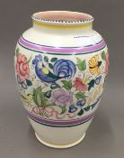 A Poole pottery vase decorated with birds and flowers in bright enamels,