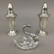 A pair of sterling silver glass lined salt and pepper cruets,