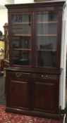 A Victorian glazed walnut bookcase cabinet