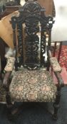 A Victorian carved oak open armchair