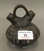 A Pre-Columbian pottery twin spouted vessel with sgraffito decoration