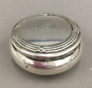 A small silver pill box