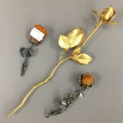 Two amber mounted white metal rose form flower brooches and another gilt metal flower