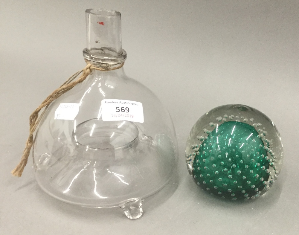 A glass wasp trap and a paperweight