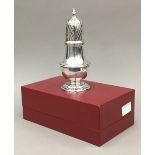 A silver sugar castor,