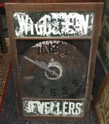 An early 20th century glass fronted shops clock for Wigg and Son Jeweler