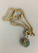 An antique pendant on chain formed from two scarab beetles