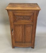 A Victorian carved oak side cabinet